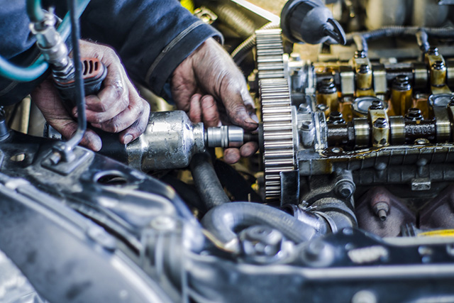 Mechanic working with with engine in a workshop